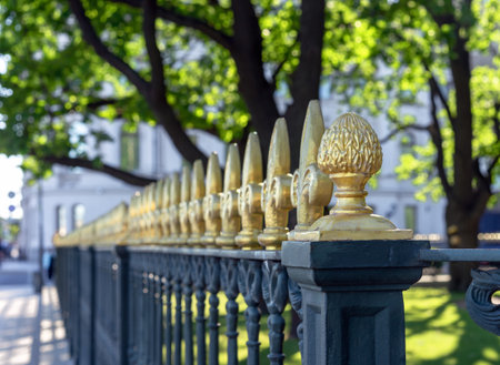 Cast iron fence with decorative gold finials on a street in St. Petersburg.の写真素材