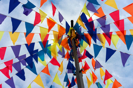 Garland of multi-colored fabric flags on the streets of the city during the holiday.の写真素材