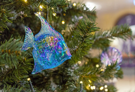 Blue glass fish with mother-of-pearl scales on a Christmas tree.の写真素材