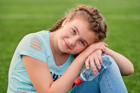 A young bright girl loves sports.closeup of young girl holding clean water.の写真素材