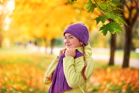 smiling teenage girl relaxing in autumn Park yellow.yellow.autumn portrait of baby in maple leafの写真素材