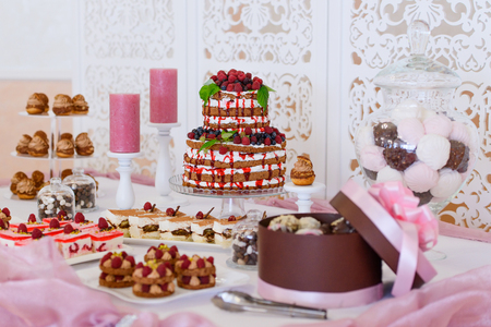 holiday cakes and serve.sweet desserts with berries and fruit .Wedding cake made of fruits and berries on a festive table.の写真素材
