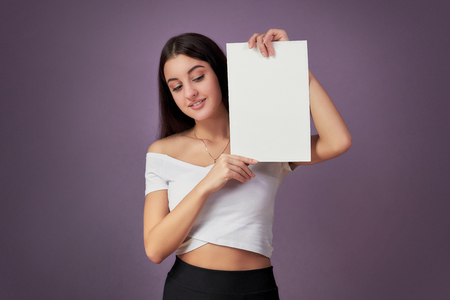 woman portrait with blank white board.Teenager girl hold white blank paper.の写真素材