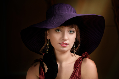 lady in a hat. Elegant woman, close-up portrait, evening style. Lovely women retro portrait. copy-space. Space for text, advertising and banner.の写真素材