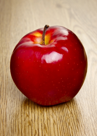 Red apple on wooden tableの写真素材
