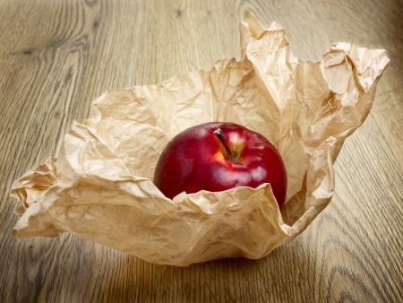 Red apple on wrapping paperの写真素材