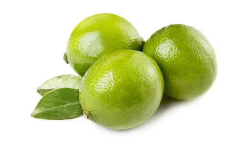 Three ripe fresh limes with leaves isolatedの写真素材