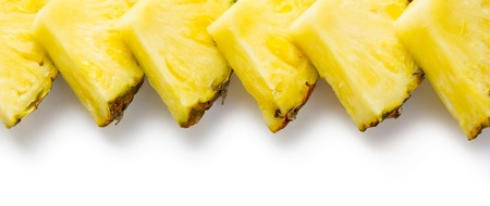 Slices of pineapple isolated on whiteの写真素材