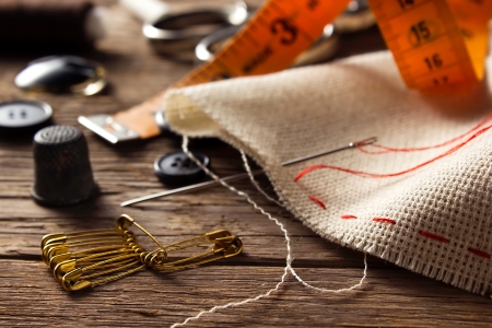 Sewing accessories on wooden backgroundの写真素材