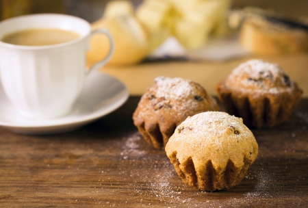 Breakfast: muffins and coffee on wooden tableの写真素材
