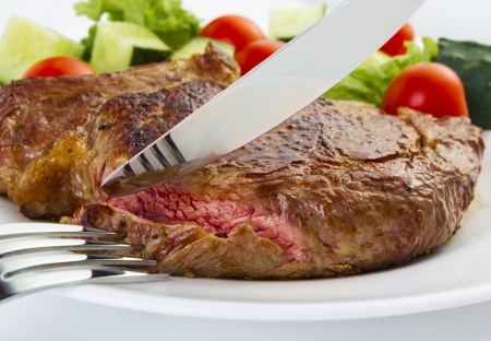 Juicy steak with fork and knifeの写真素材
