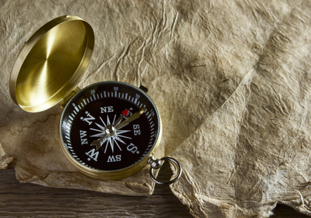 Old compass and paper on wooden backgroundの写真素材