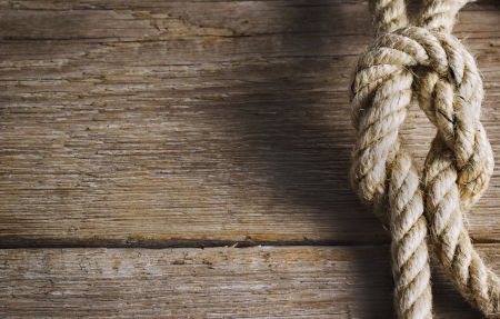 Old wood with rope knotの写真素材