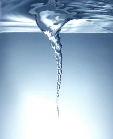Whirlpool under blue clean waterの写真素材