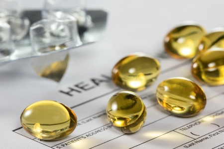 Cod liver oil capsules on health insurance formの写真素材