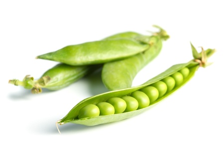 Fresh green peas isolated on whiteの写真素材
