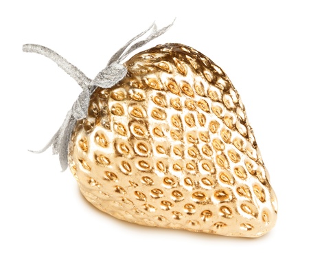 Gold strawberry with silver leaves isolated on whiteの写真素材