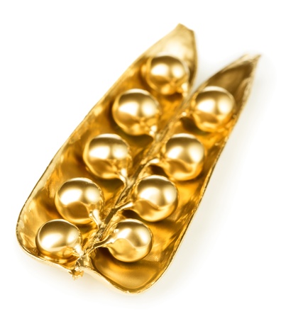 Gold pea pod isolated on whiteの写真素材
