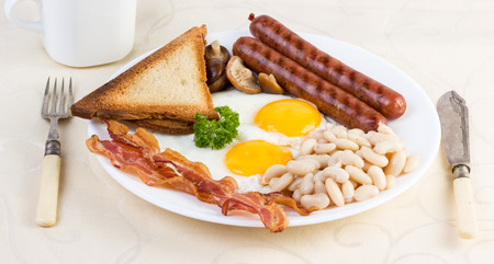 English breakfast: eggs, beans, sausages, bacon and mushroomsの写真素材