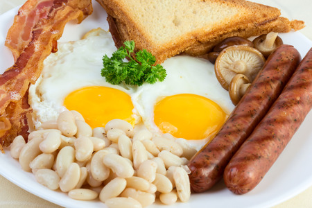 English breakfast: eggs, beans, sausages, bacon and mushroomsの写真素材