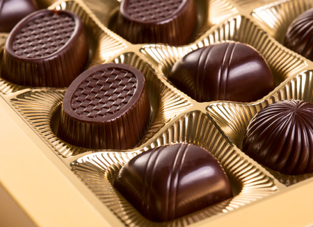 A box of various chocolate candiesの写真素材