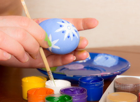 Young woman painting Easter eggsの写真素材