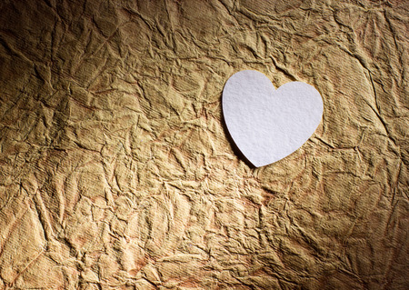 White heart shape on vintage papper backgroundの写真素材