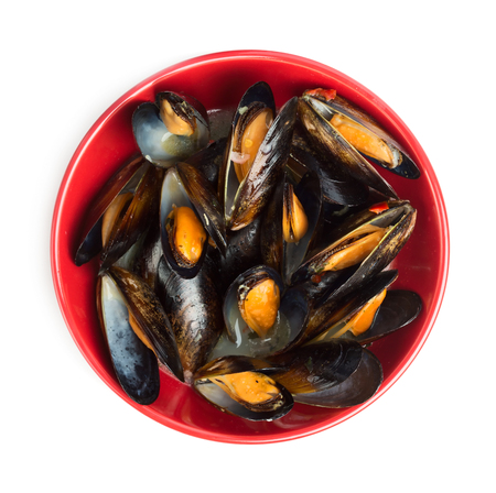 Prepared mussels in red pot isolated on white backgroundの写真素材