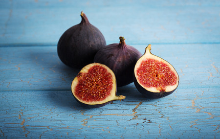 Fresh figs on blue wooden table background