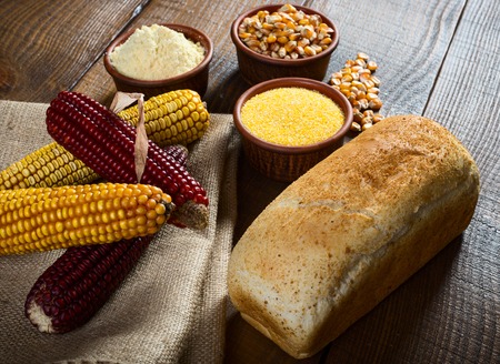 Corn cobs, seeds, groats, flour and bread , raw food conceptの写真素材