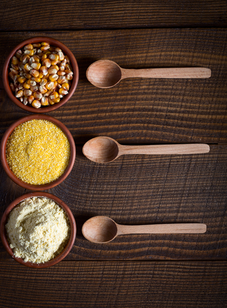 Idea for menu card: corn seeds, groats and flour on wooden backgroundの写真素材