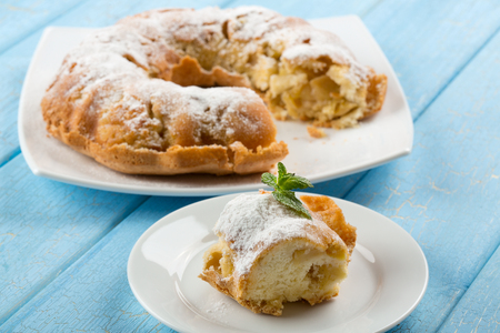 A Piece of Apple Crumble Spicy Pie or Cake on blue wooden backgroundの写真素材