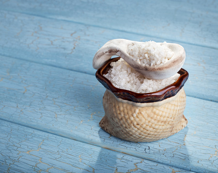 Sea salt crystals on blue wooden backgroundの写真素材
