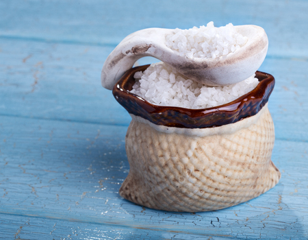 Sea salt crystals on blue wooden backgroundの写真素材