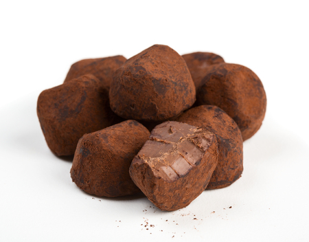 Close up view of chocolate truffles isolated on white backgroundの写真素材