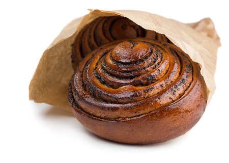 Buns with poppy seads in paper bag isolated on white backgroundの写真素材