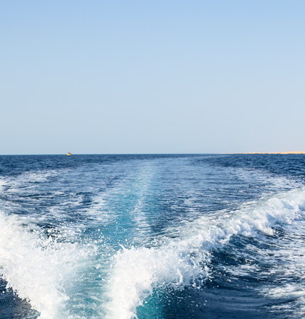 Background water surface behind of fast moving motor boatの写真素材