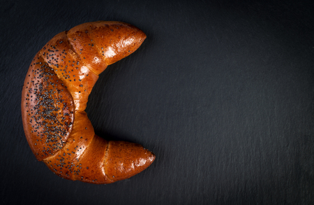Shape of moon made from homemade croissant on black backgroundの写真素材