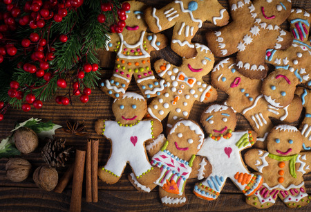 Christmas Gingerbread men and wreath of holly berry with spicesの写真素材