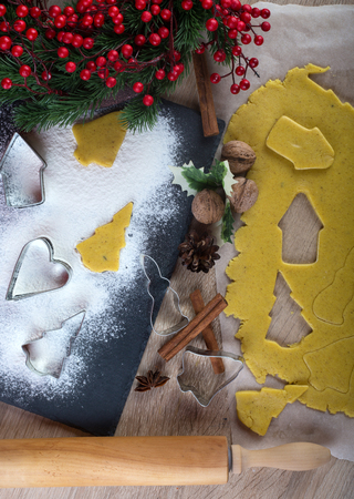 Christmas baking: ginger biscuit with holly berry decorationの写真素材