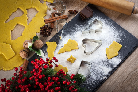 Christmas baking: ginger biscuit with holly berry decorationの写真素材