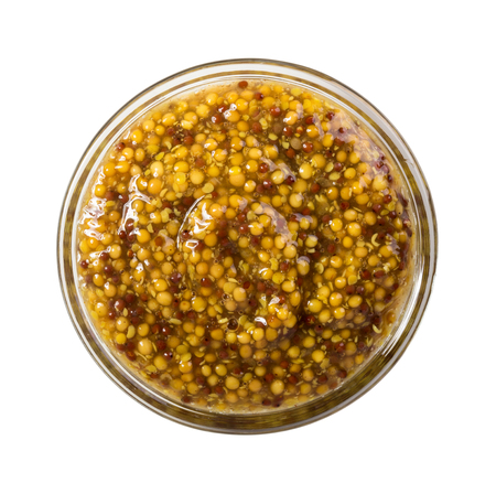 Top view of mustard in glass bowl isolated on white backgroundの写真素材