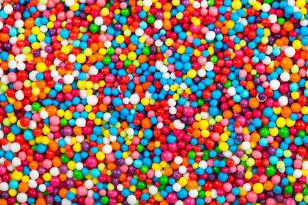 Multicolored background made from sweet sprinkles ballsの写真素材