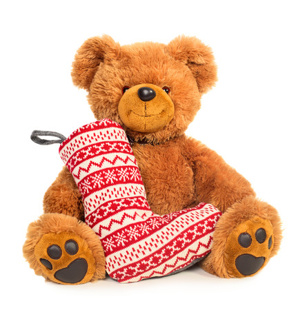 Teddy bear with Christmas stocking isolated on white backgroundの写真素材