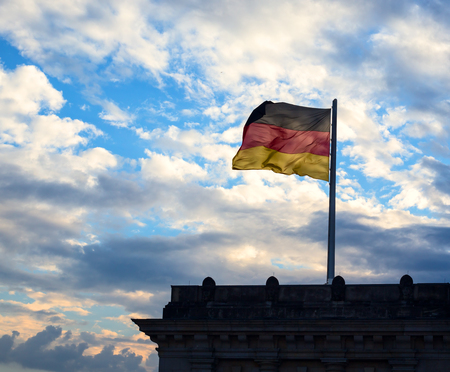 German flag on cloudy sky background in Berlin. Germanyの写真素材