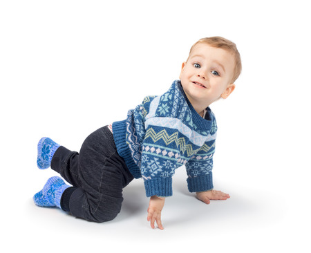 Cute little boy crawls isolated on white backgroundの写真素材