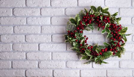 Christmas wreath on brick wall background. Holiday conceptの写真素材