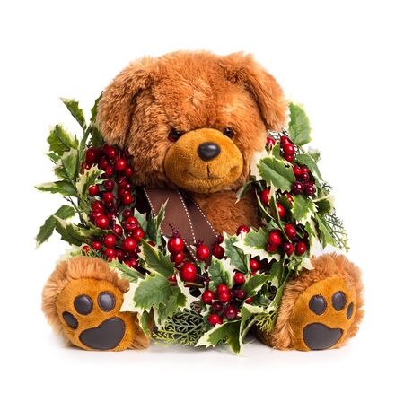 Teddy bear with Christmas wreath isolated on white backgroundの写真素材