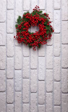 Christmas wreath on brick wall background. Holiday conceptの写真素材