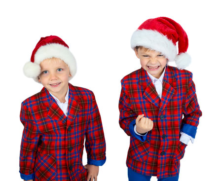 Little boys dressed like small santa, with christmas hats, isolated on white backgroundの写真素材